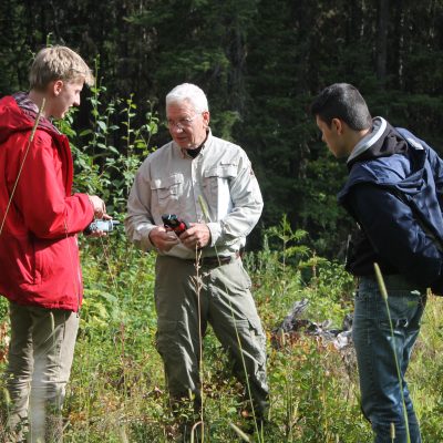 IE Technicians Shay Hatten and Jed Sharrard get a tutorial by Dwight Bergerone on orienteering and bear safety